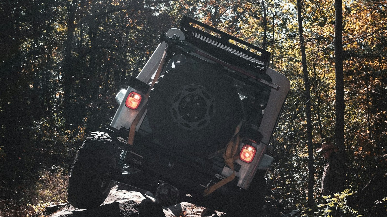 Jeep Wrangler working up a rocky forest trail