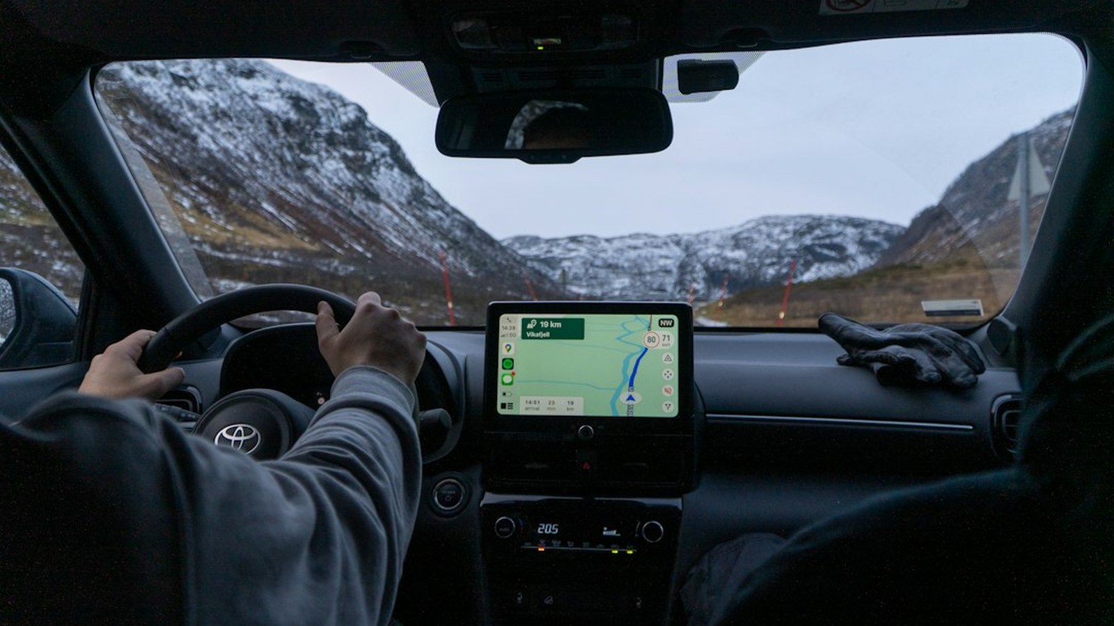 View from inside a 4x4 on a remote snowy mountain trail with a GPS navigation display running