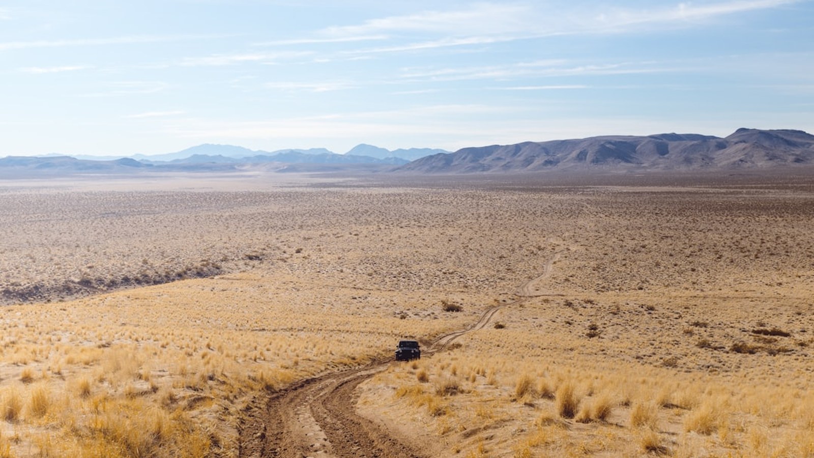 A lone 4x4 on a desert two-track after a successful self-recovery
