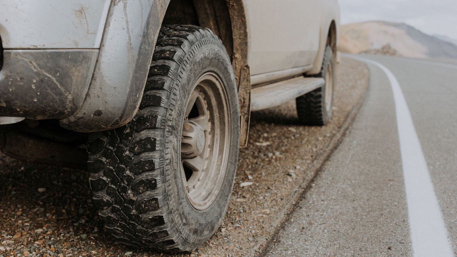 A rugged off-road vehicle tire on a gravel road, the part of the build that matters most