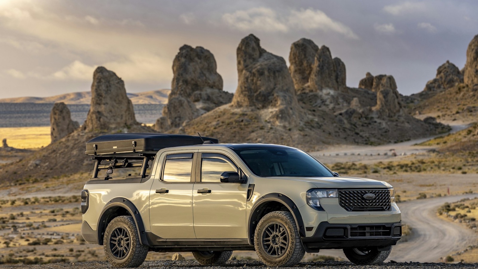 A pickup truck parked at a remote desert camp, out using the rig