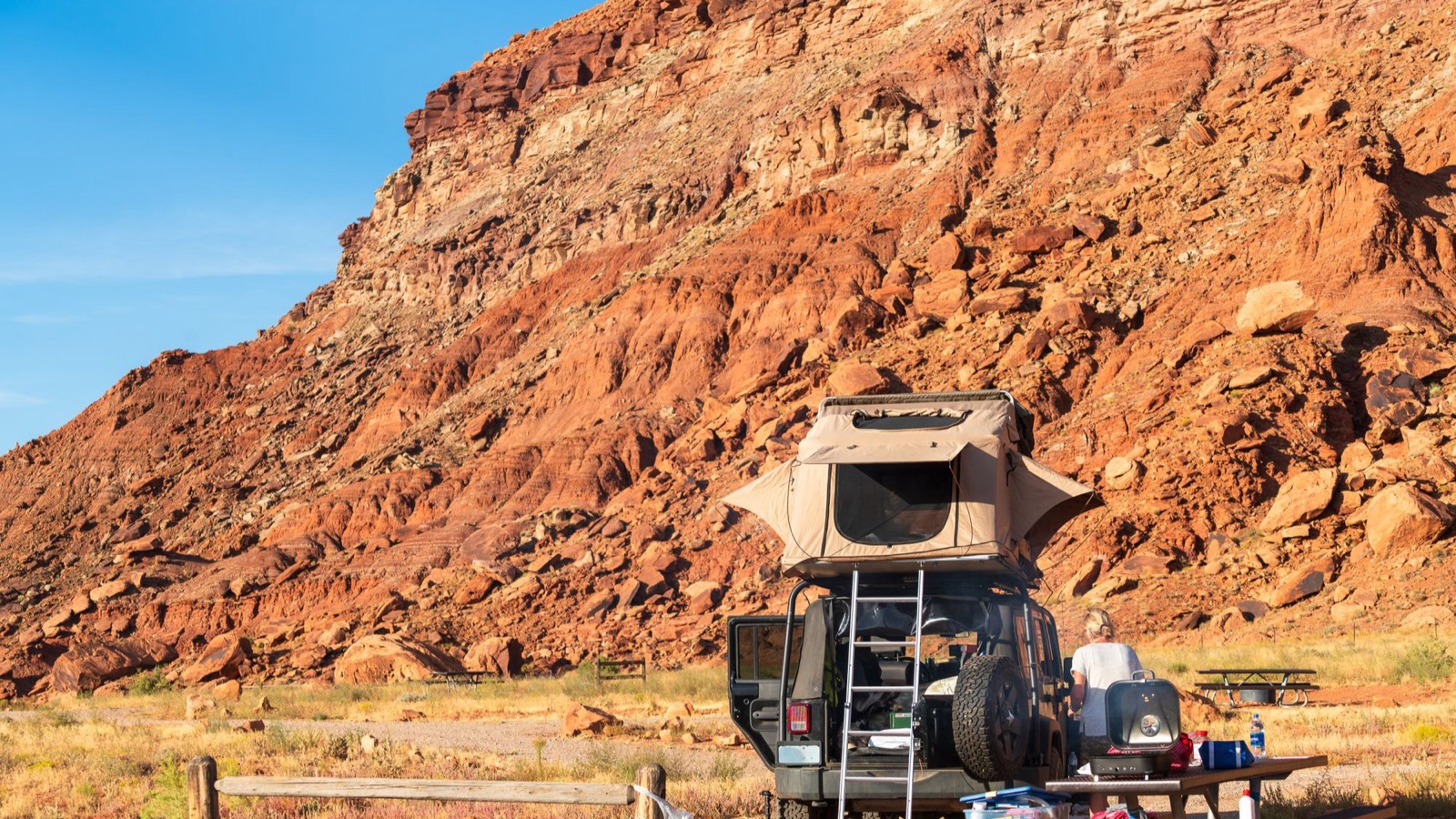 A vehicle set up with a rooftop tent at a high desert campsite
