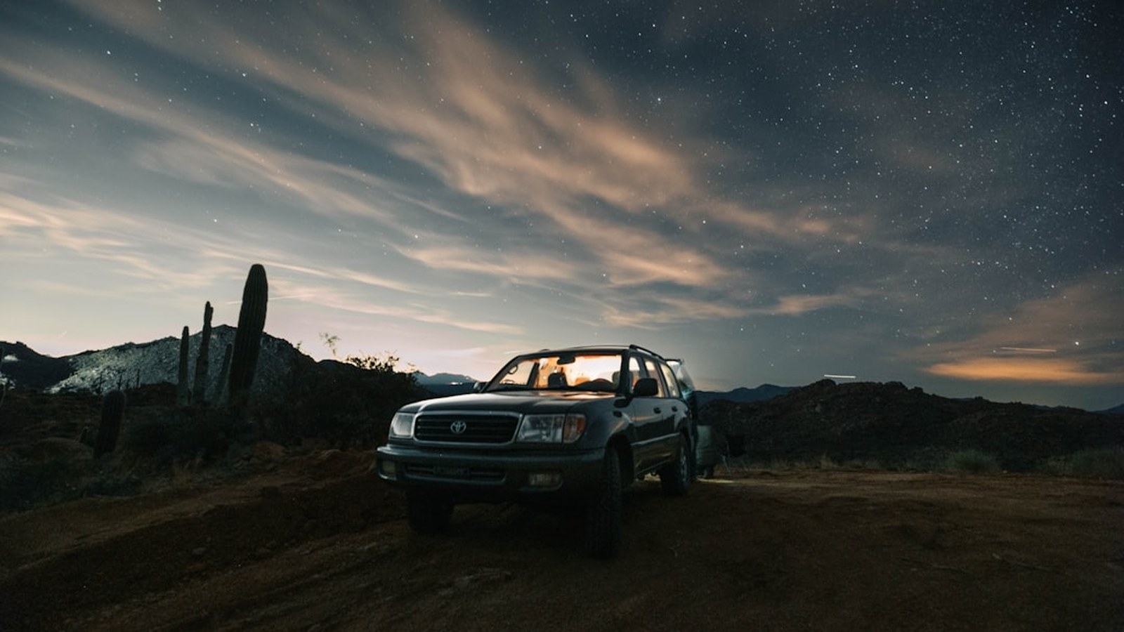 Overland rig parked on a remote desert trail far from help