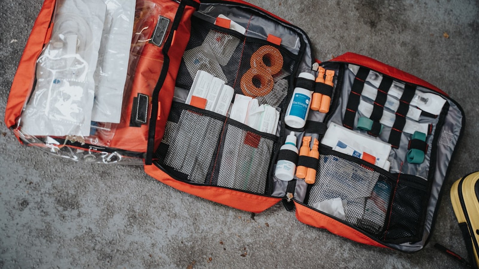 A well-stocked off-road first aid kit open with organized medical supplies