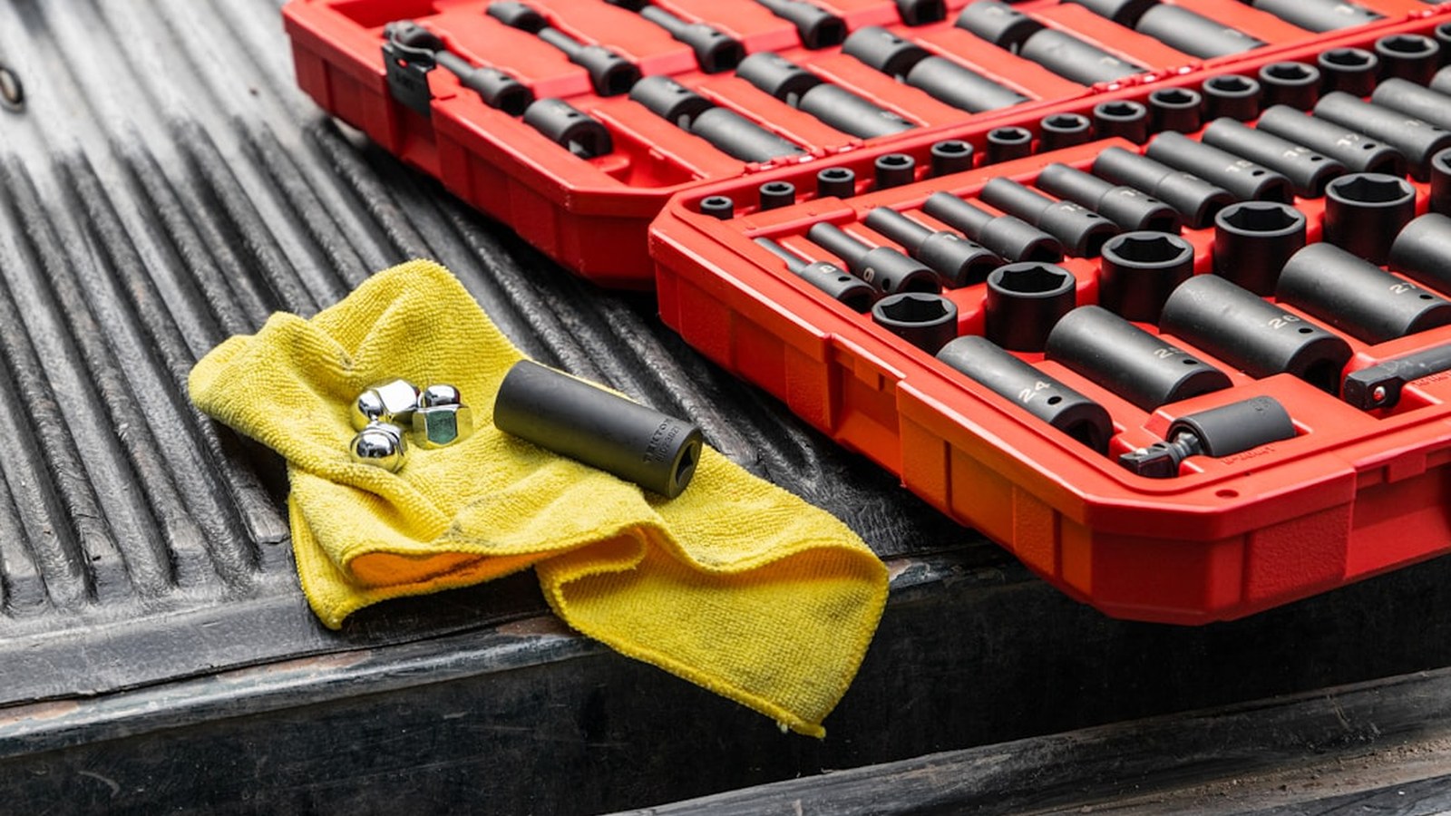A socket set and tools laid out on a truck tailgate