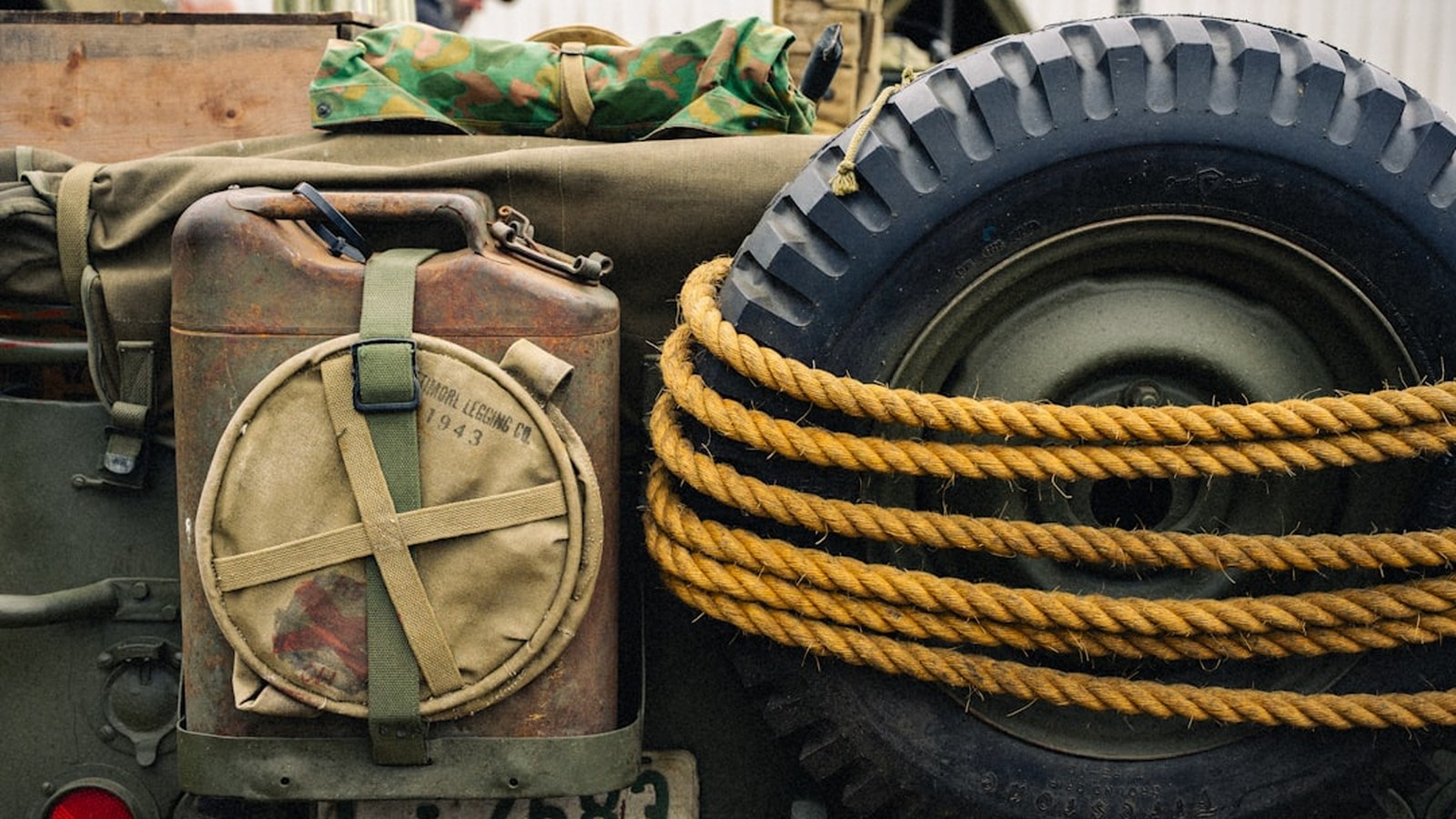 A jerry can and spare tire mounted on the back of an expedition rig