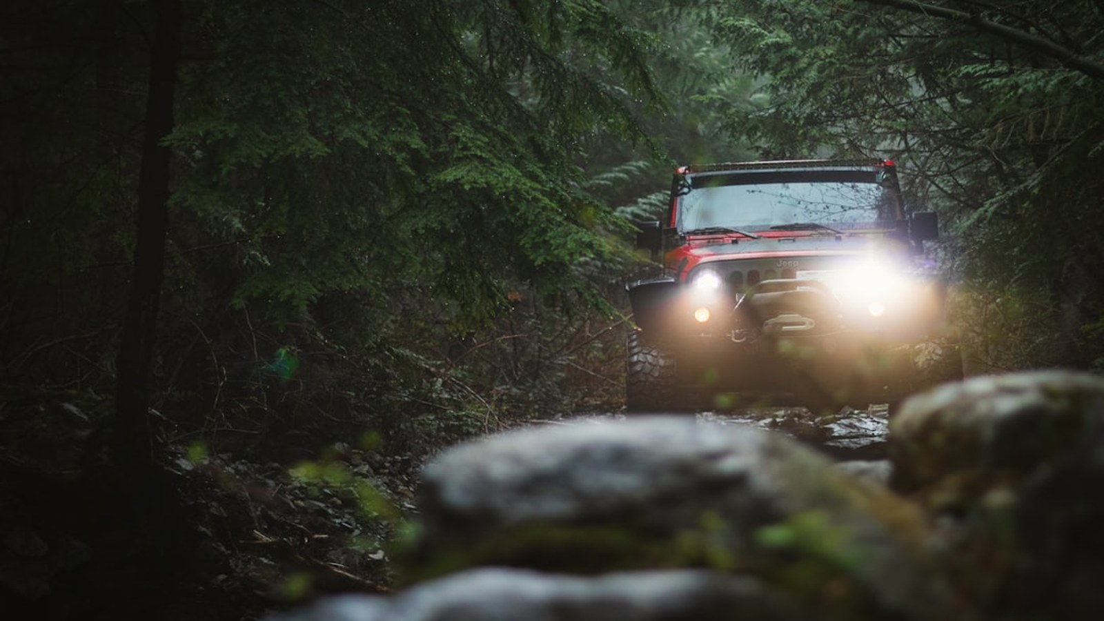 A capable Jeep Wrangler on an open two-track trail at golden hour, a clean rig kept ready by consistent care