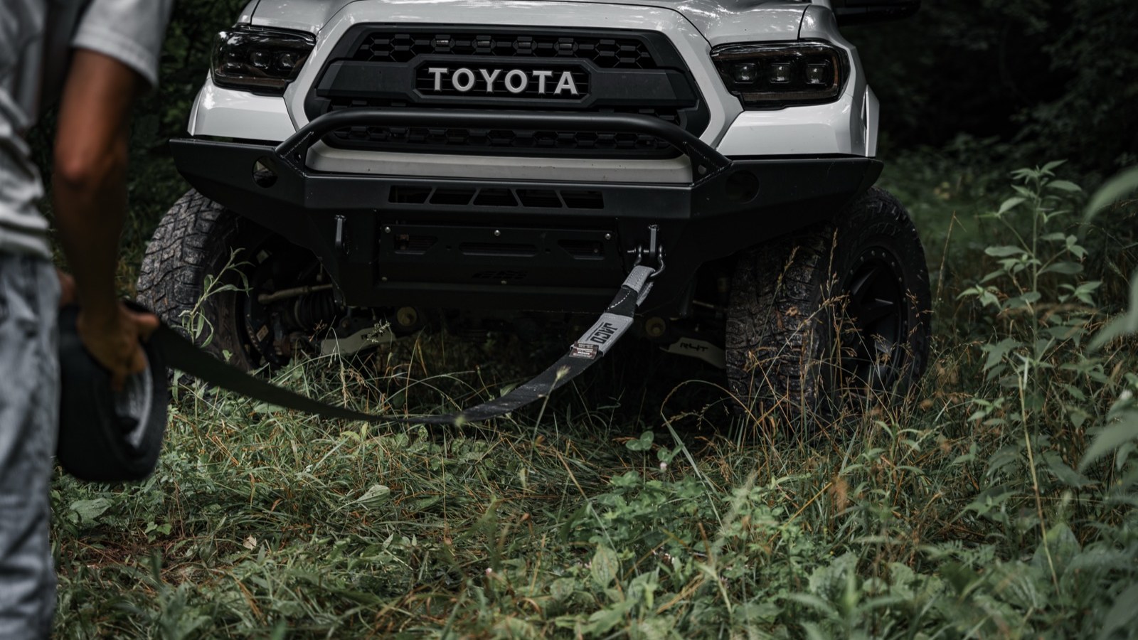 A recovery strap rigged to the front recovery point of a Toyota Tacoma