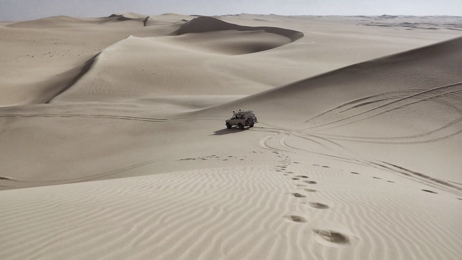 A 4x4 descending a massive sand dune where airing down and digging beat brute force