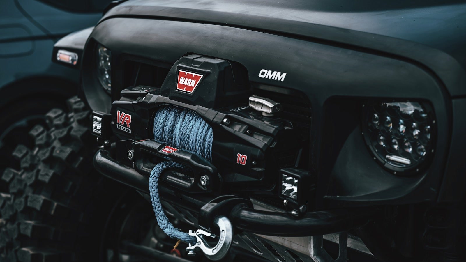 A winch with synthetic line mounted on the front of an off-road vehicle