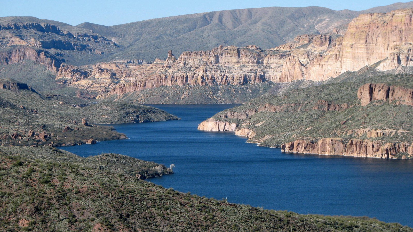 Apache Lake winding between rugged desert cliffs in the Tonto National Forest