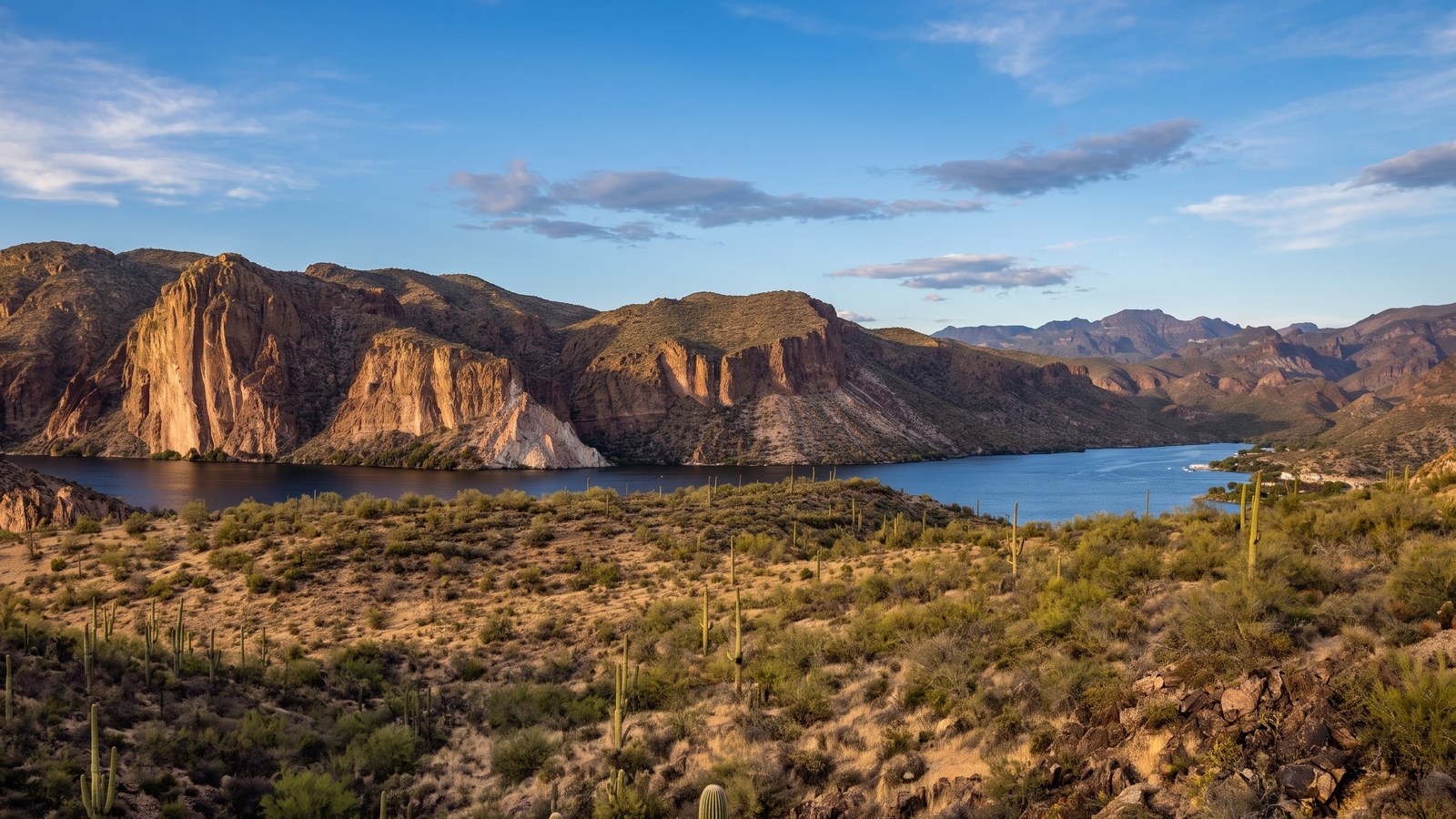 Canyon Lake, a deep blue reservoir winding between tall banded desert cliffs along the Apache Trail