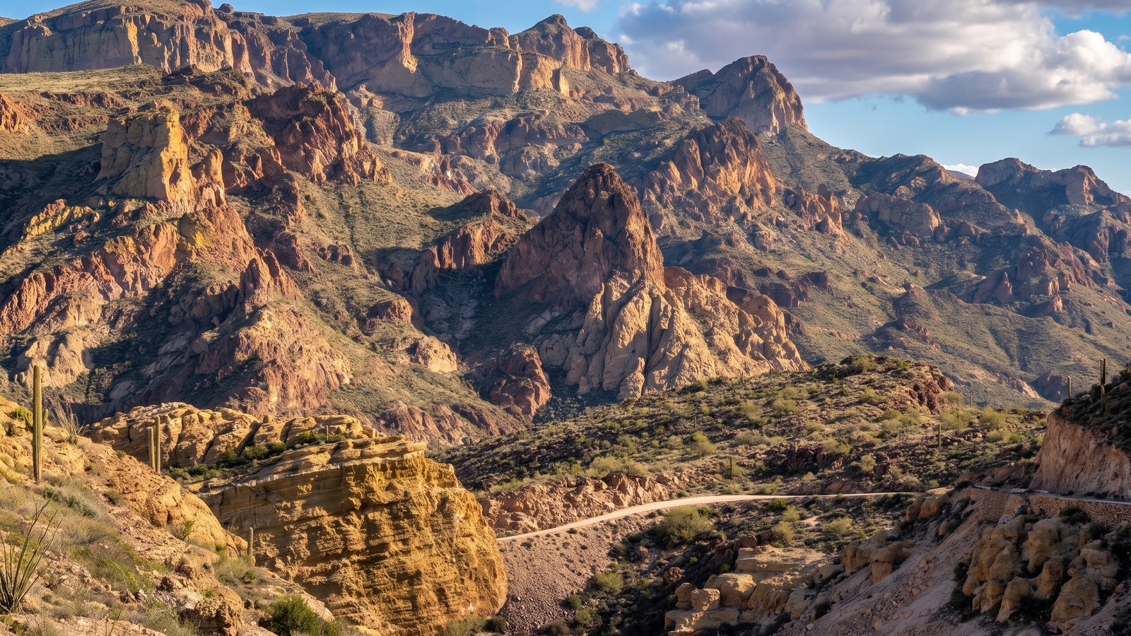 A desert canyon and the winding Apache Trail road threading below rugged Sonoran peaks