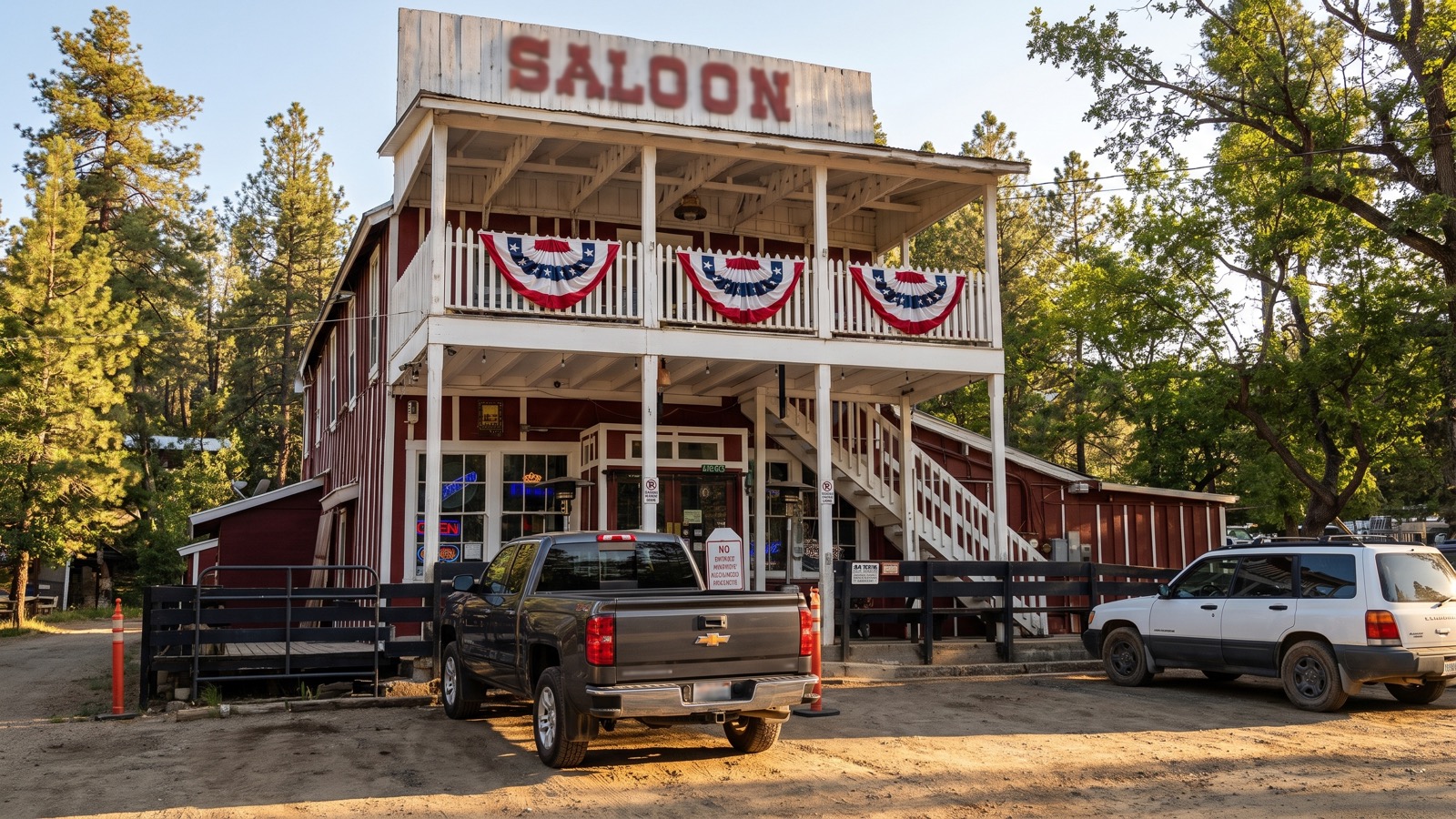 The historic Crown King Saloon, a rustic old-west wooden building with a pickup parked out front under tall pines.
