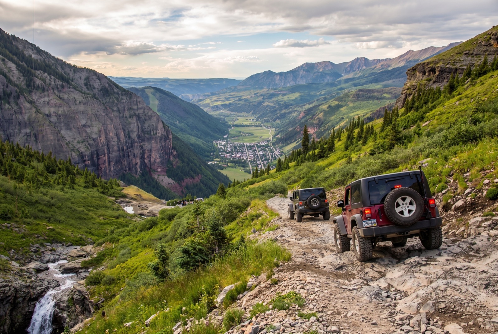 Two built Jeep Wranglers working down the narrow shelf-road switchbacks of Black Bear Pass