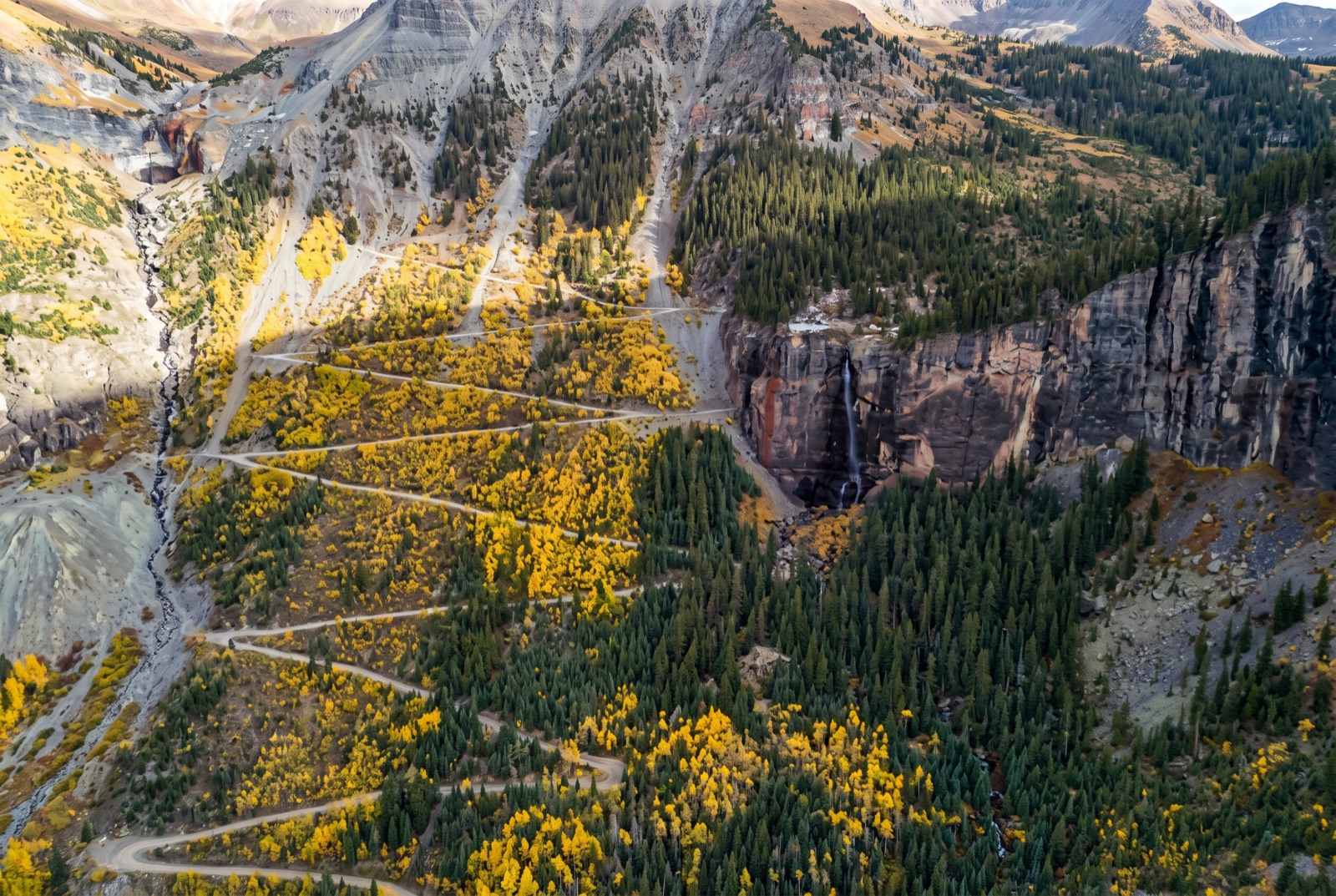 The tight stair-step switchbacks of Black Bear Pass zig-zagging down the cliff face high above the Telluride valley