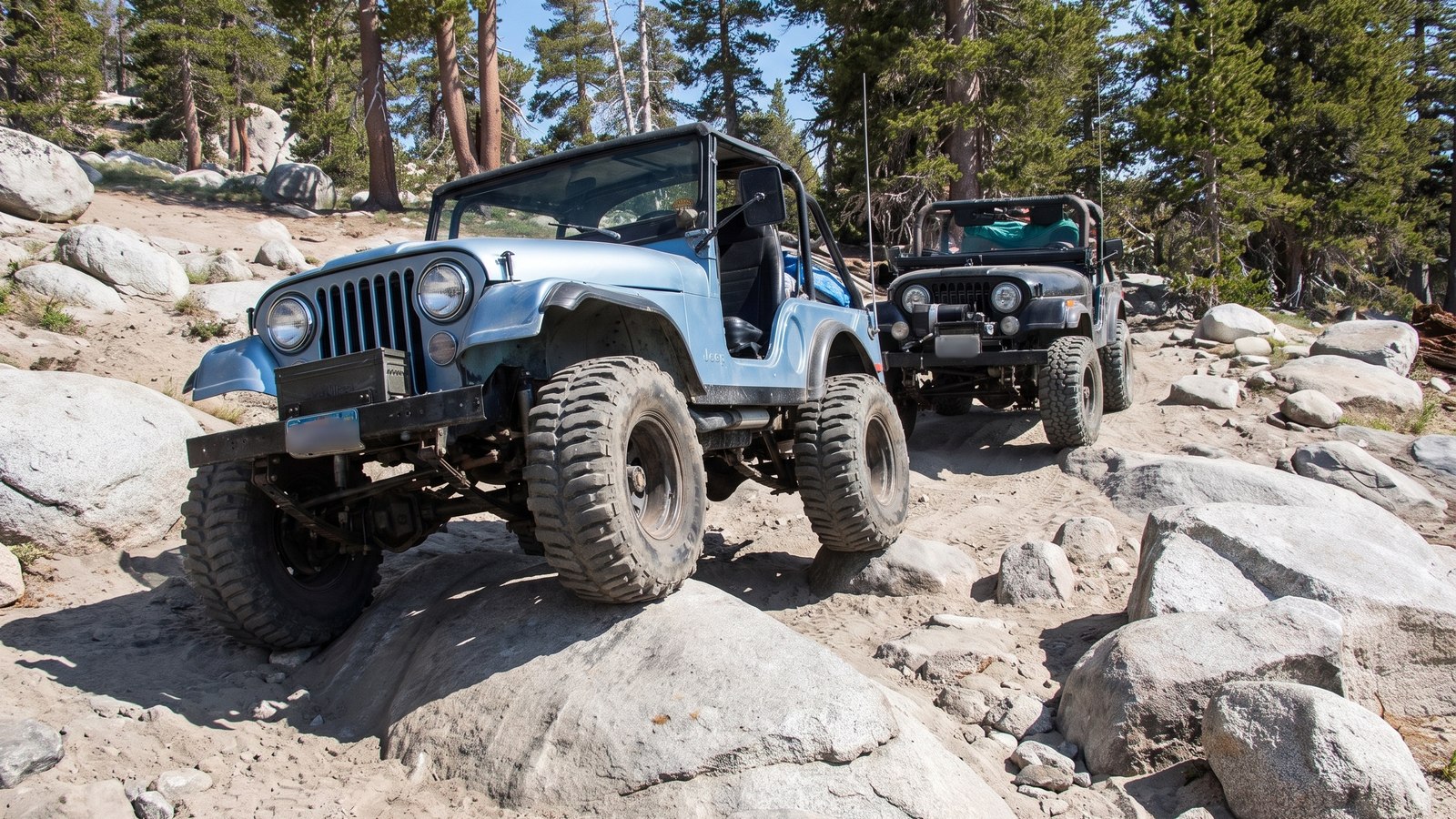 Two built rigs working through a Sierra granite descent on the Dusy-Ershim Trail, the kind of convoy travel the route demands