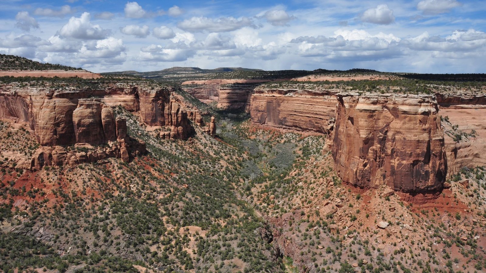 Red sandstone canyon walls and desert scrub under a deep blue sky in the Mojave desert near Nelson, Nevada