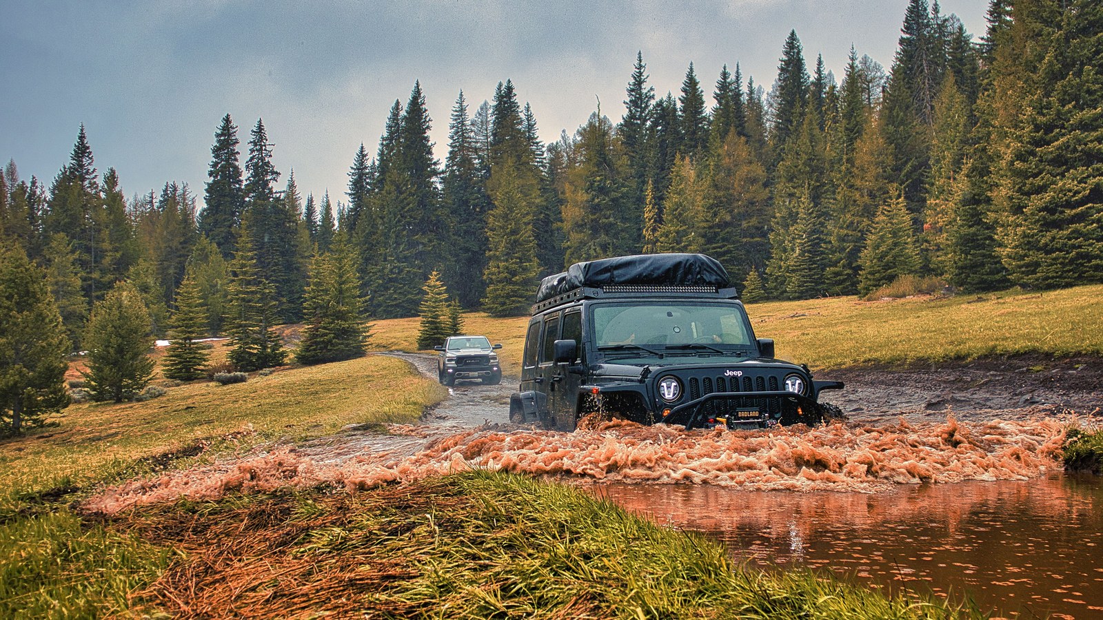 A 4x4 articulating hard over boulders, illustrating the steep, technical rock that defines a Fordyce winch hill