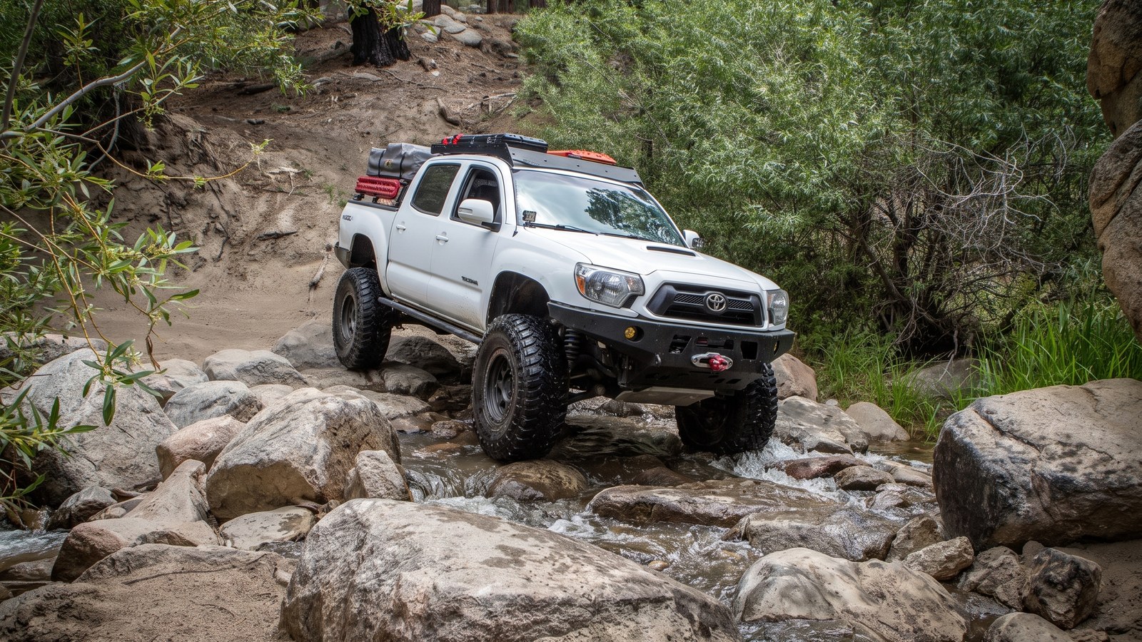 A 4x4 easing down onto wet granite at one of the Holcomb Creek water crossings.