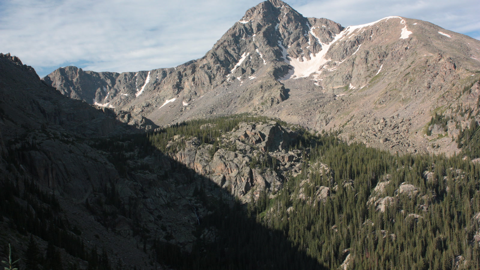 Mount of the Holy Cross rising above the alpine wilderness, the 14,009-foot Sawatch peak whose cross-shaped snowfield gives the trail and ghost town their name