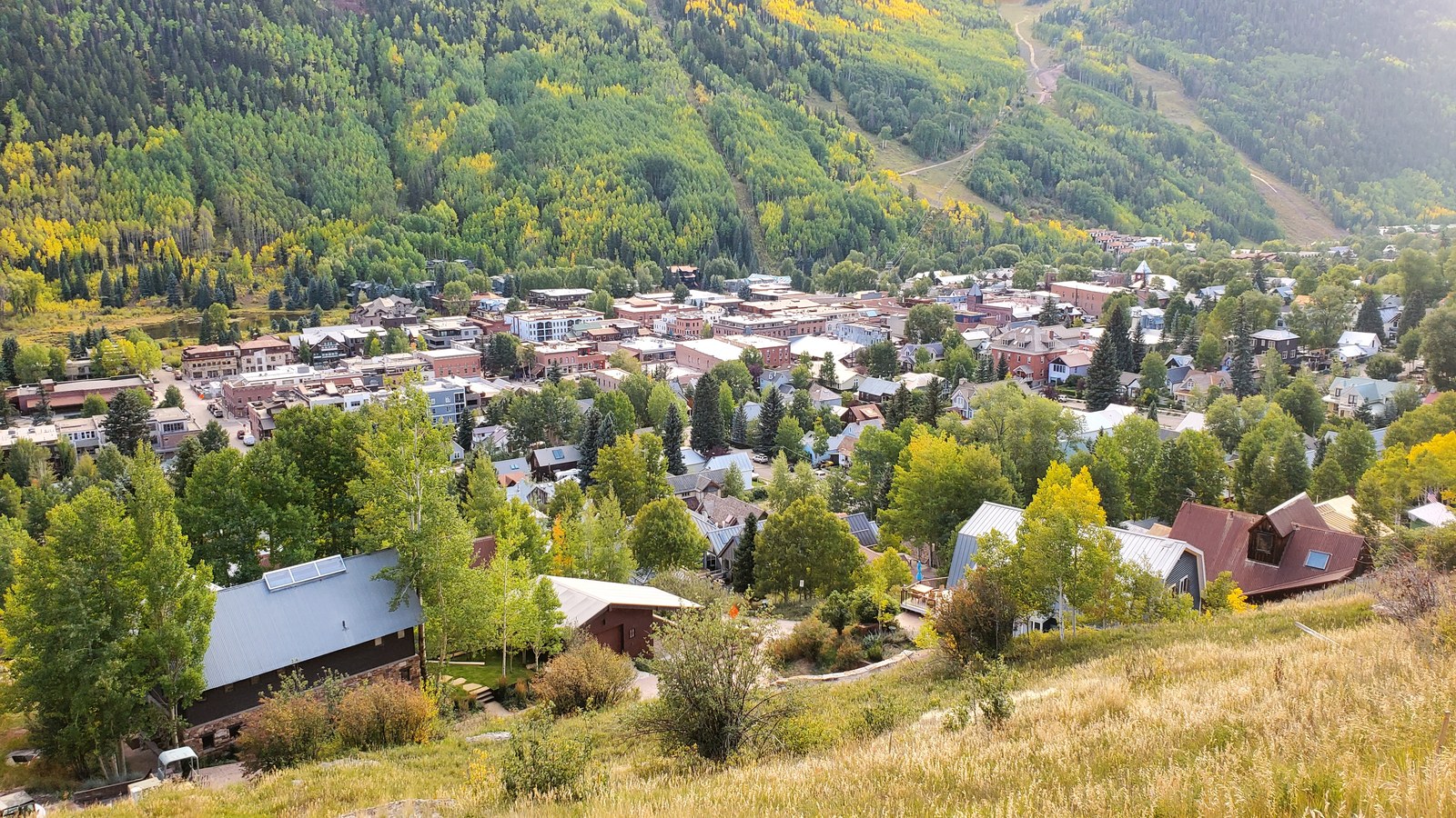 The town of Telluride tucked into its box canyon below the slopes, the western terminus of the Imogene Pass crossing