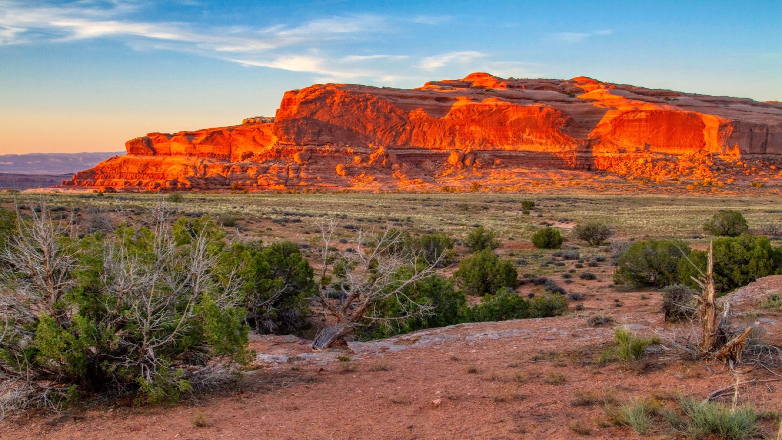 Glowing red sandstone formations at golden hour in the Moab high desert