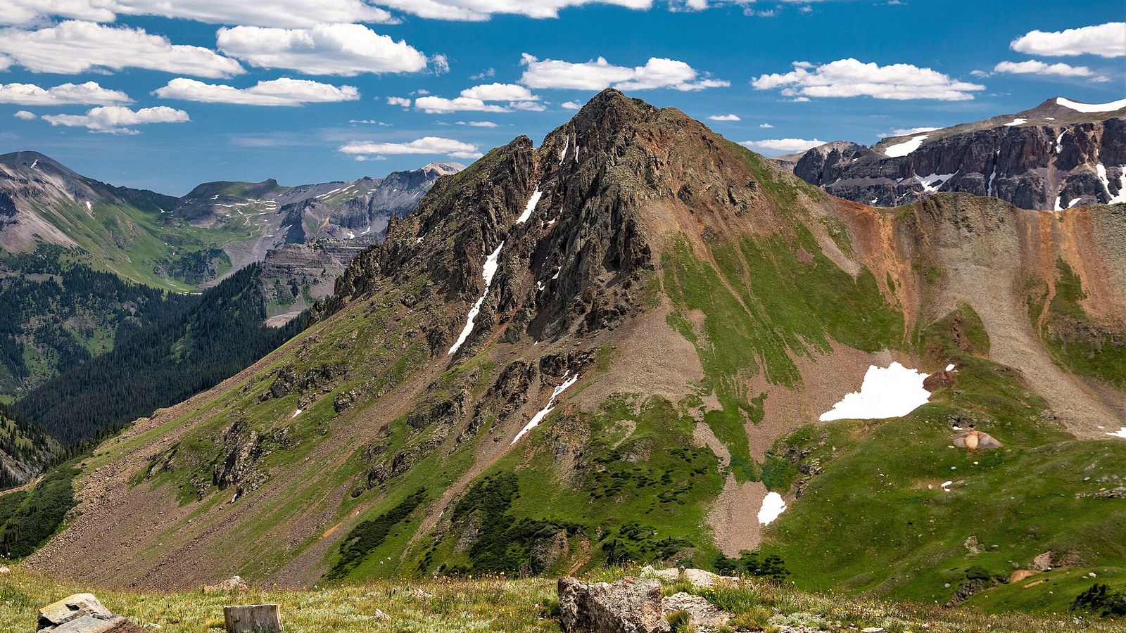Stony Mountain rising above the green tundra of Yankee Boy Basin under a bright summer sky